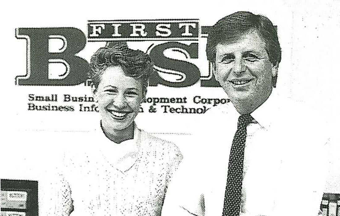 Photo of SBDC staff standing in front of a 'First Base' sign.