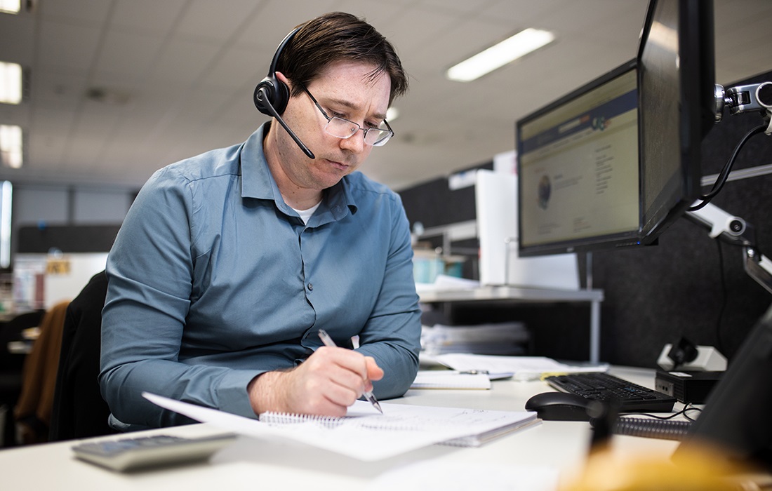 Photo of an SBDC business adviser on the phone to a small business owner.